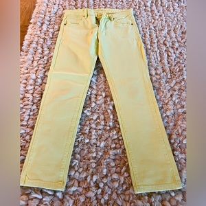 BCBG yellow jeans with gold buttons.